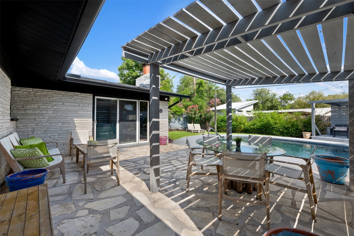 1806 Rogge Lane Austin, TX 78723 - Photo 30 of 40 a view of a patio with a table chairs and a small yard