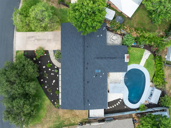 an aerial view of a house with outdoor space