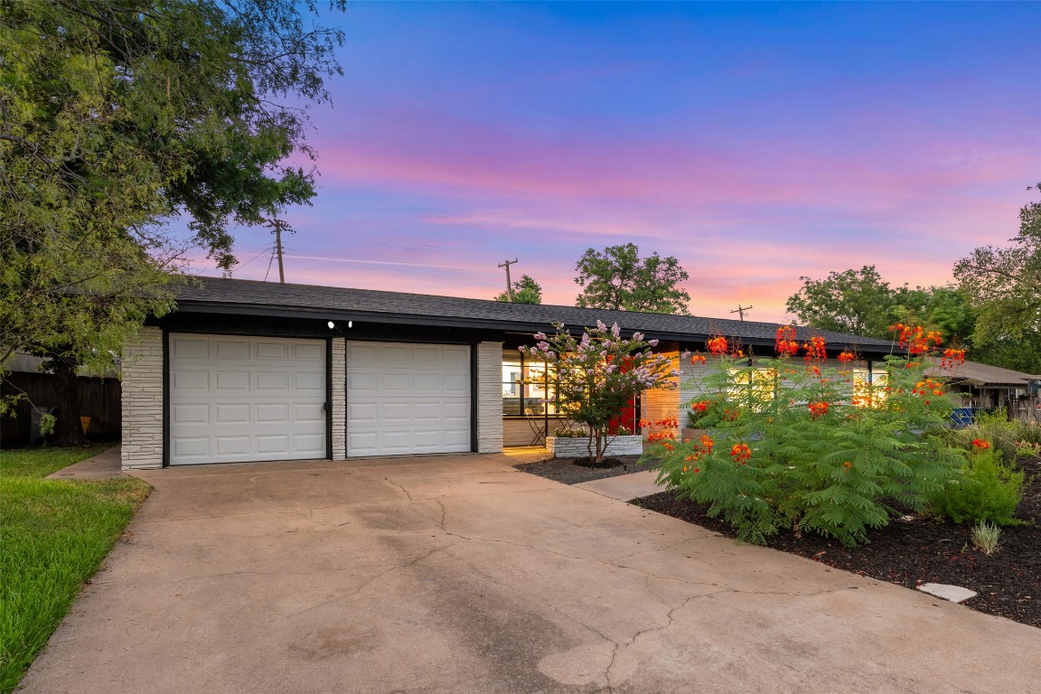 1806 Rogge Lane Austin, TX 78723 - Photo 36 of 40 a front view of a house with a yard and garage