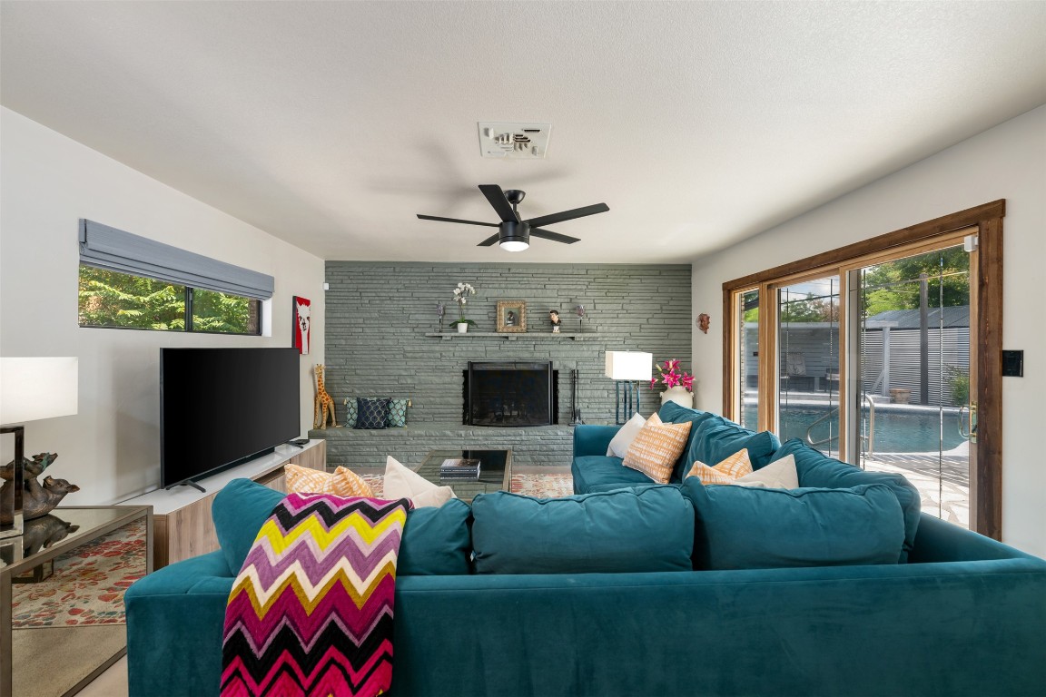 1806 Rogge Lane Austin, TX 78723 - Photo 4 of 40 a living room with furniture a fireplace and a flat screen tv