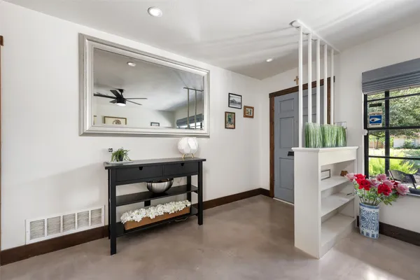 a dining room with furniture and wooden floor