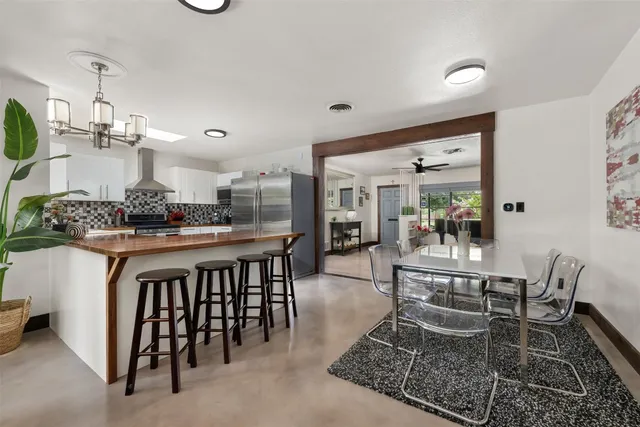 a kitchen with a table and chairs in it