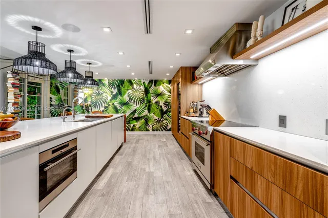 a kitchen with stainless steel appliances a sink and stove