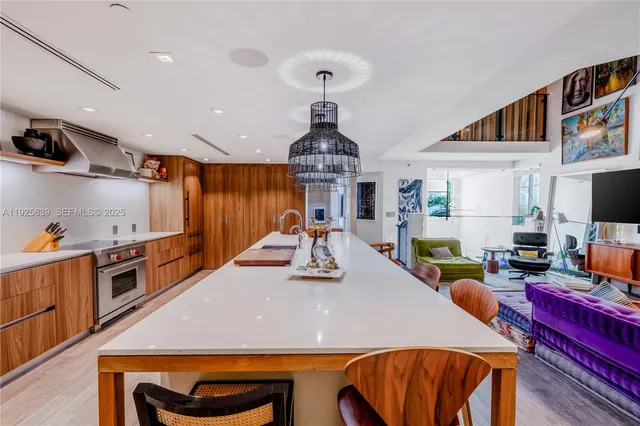 a kitchen with sink a stove and chairs
