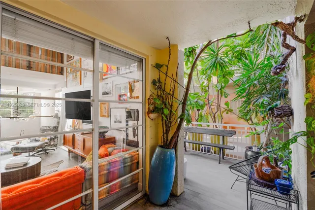 a bedroom with a bed bookshelf and a large window