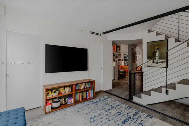 a living room with furniture and wooden floor