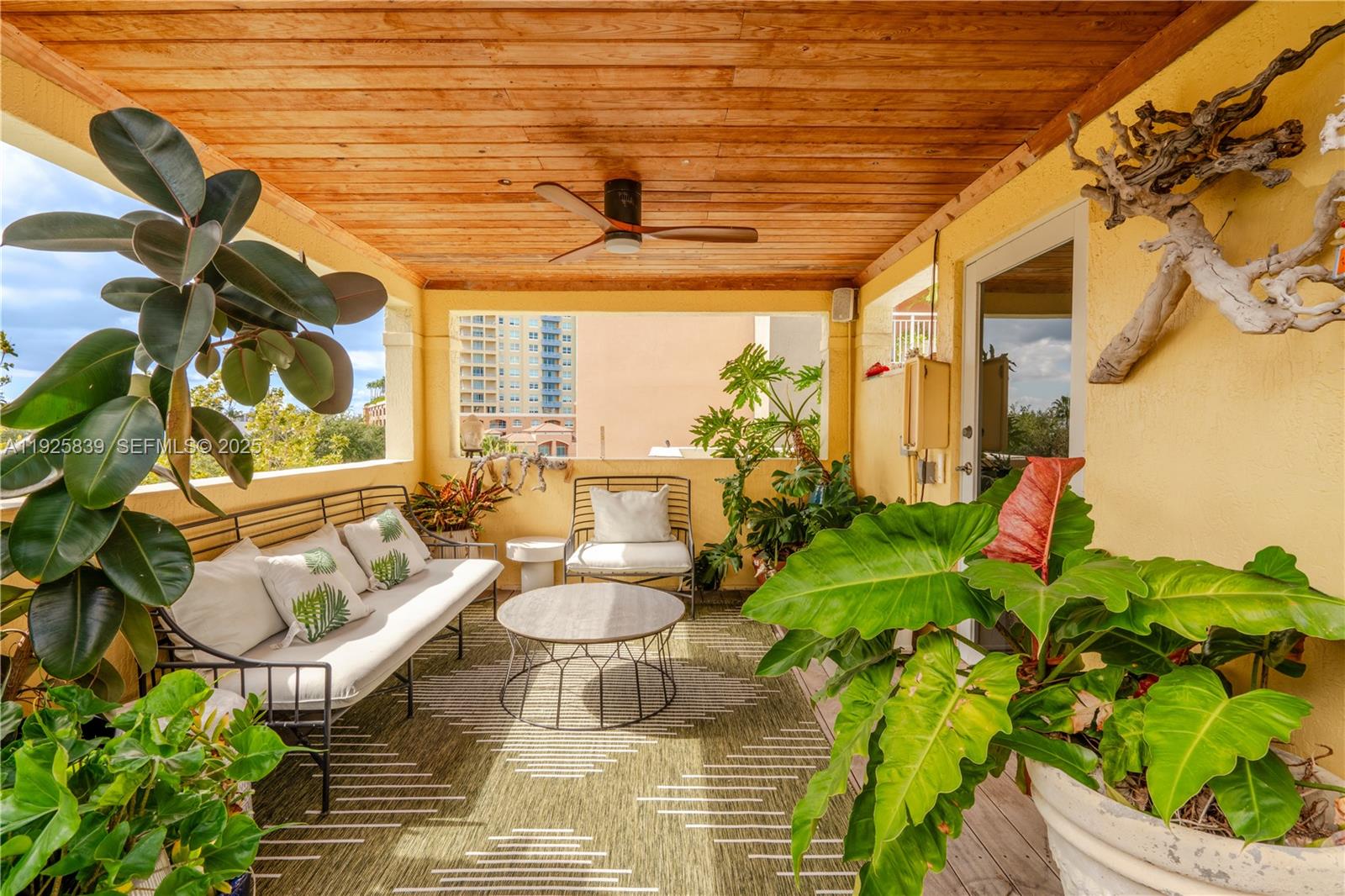 125 Jefferson Avenue, Unit 119 Miami Beach, FL 33139 - Photo 3 of 47 a living room with patio furniture and a potted plant