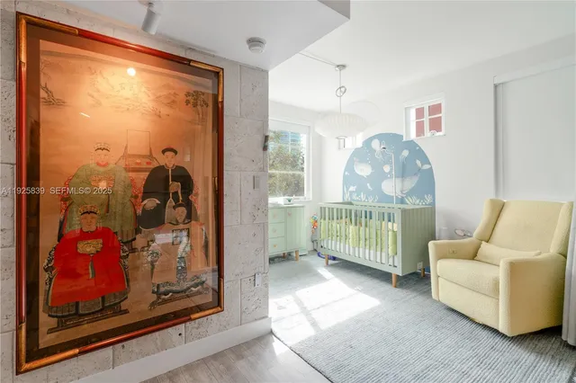 a bedroom with furniture and a window