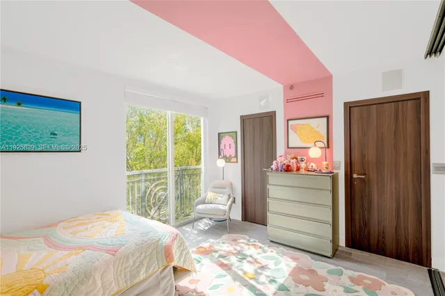 a living room with furniture a potted plant and a fireplace