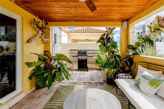 a balcony with furniture and a potted plant