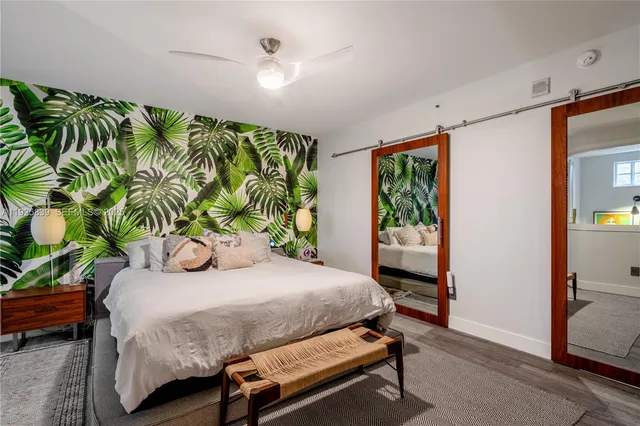 a bedroom with a bed window and table