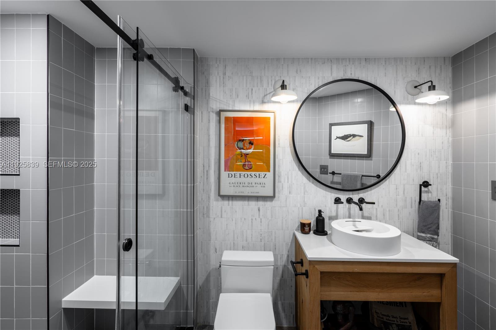 125 Jefferson Avenue, Unit 119 Miami Beach, FL 33139 - Photo 7 of 47 a bathroom with a sink a mirror a vanity and a shower