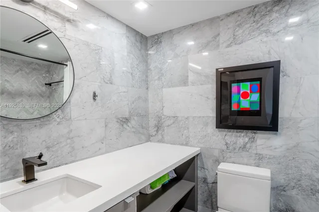 a bathroom with a sink a mirror and a shower