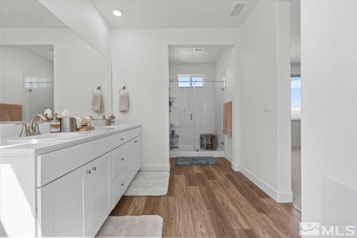 10385 Alchemy Court Reno, NV 89521 - Photo 17 of 40 a spacious bathroom with a sink mirror and a bath tub