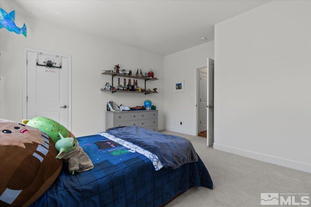10385 Alchemy Court Reno, NV 89521 - Photo 19 of 40 a bedroom with a bed and a window