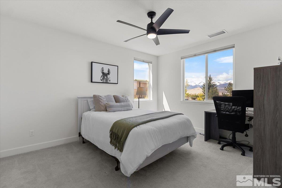 10385 Alchemy Court Reno, NV 89521 - Photo 20 of 40 a spacious bedroom with a bed and a desk