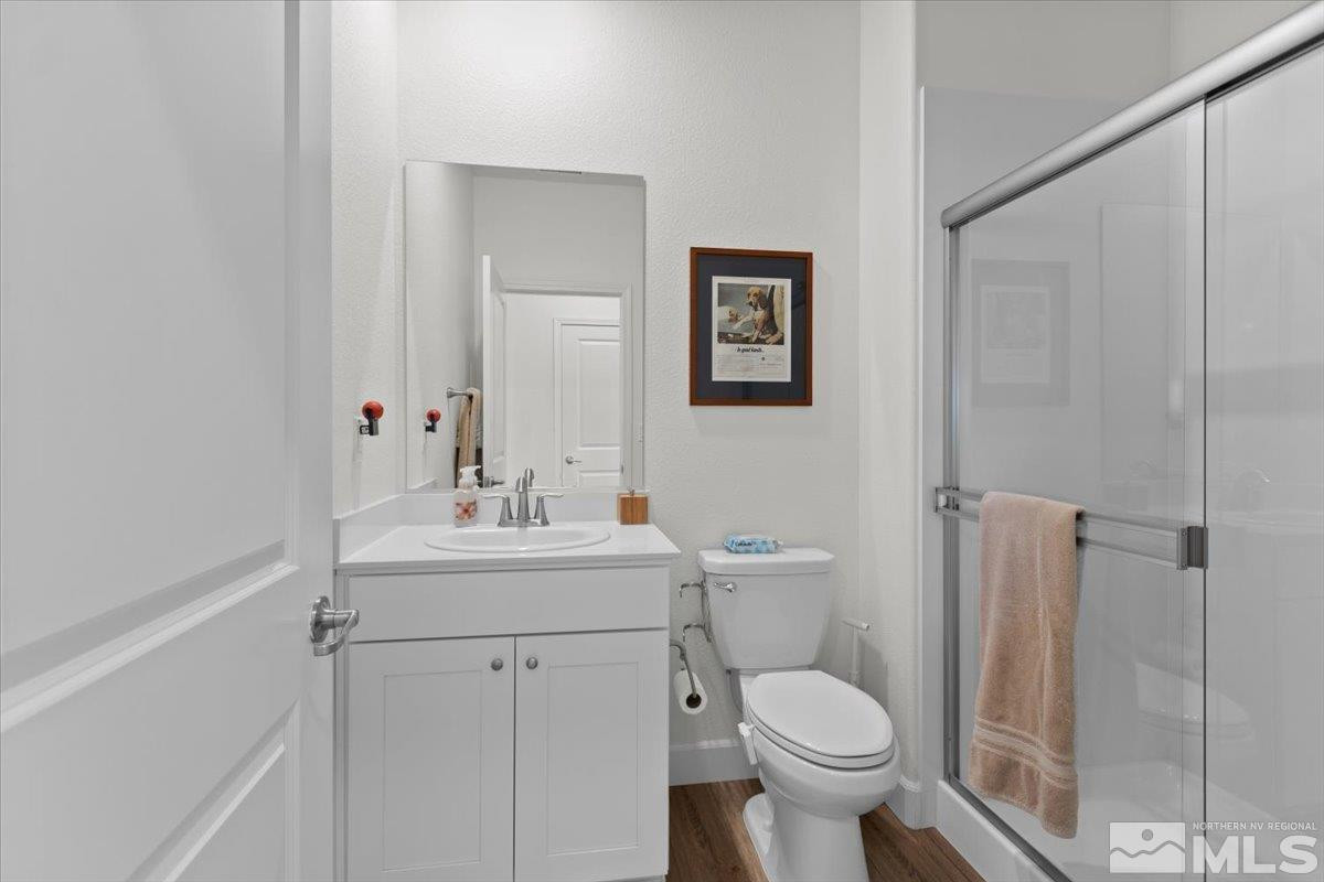 10385 Alchemy Court Reno, NV 89521 - Photo 24 of 40 a bathroom with a toilet sink and mirror