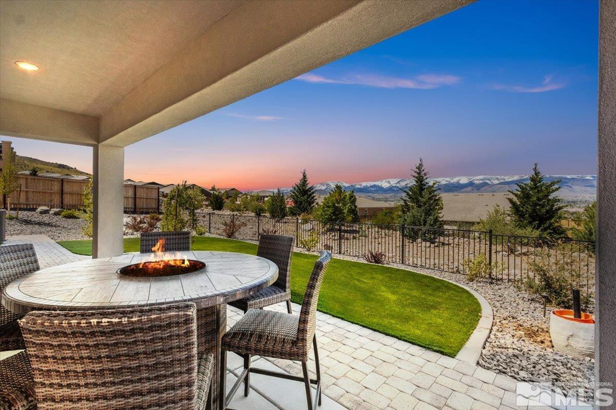 10385 Alchemy Court Reno, NV 89521 - Photo 31 of 40 a view of a swimming pool with a table and chairs