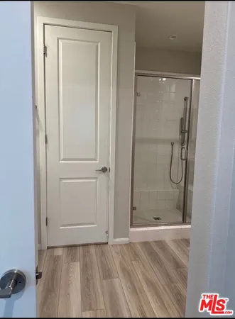 a bathroom with a glass shower door