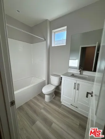 a bathroom with a toilet a sink and bathtub