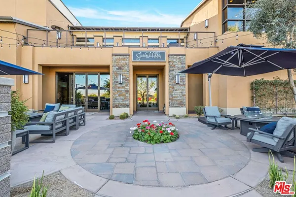 a patio with a table and chairs