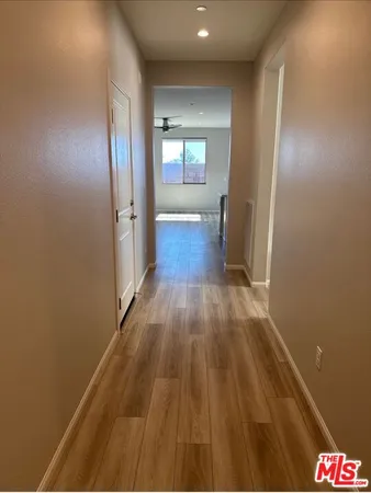 a view of hallway with wooden floor