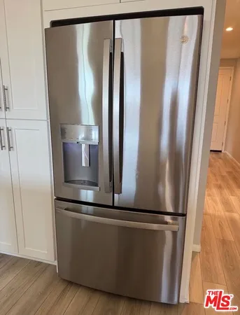 a view of a refrigerator in kitchen and wooden floor