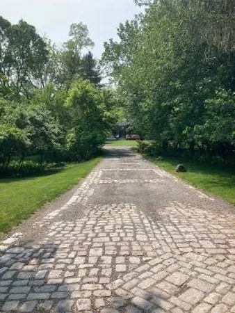a view of a pathway with a yard