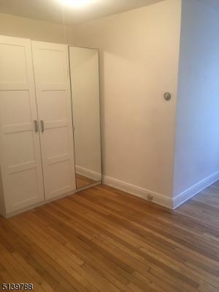 679 Mountain Boulevard, Unit 6 Watchung, NJ 07069 - Photo 11 of 13 a view of an empty room with wooden floor