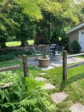 a backyard of a house with yard and outdoor seating