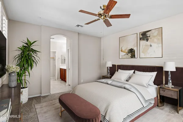 a bedroom with a bed and a potted plant