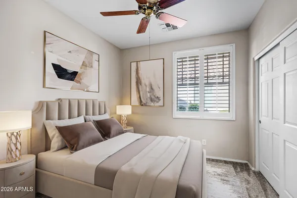 a bedroom with a large bed and a window