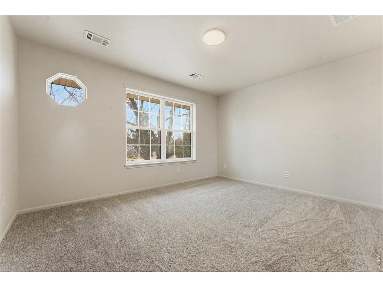 2551 West 24th Street, Unit A6 Greeley, CO 80634 - Photo 12 of 28 a view of an empty room with a window