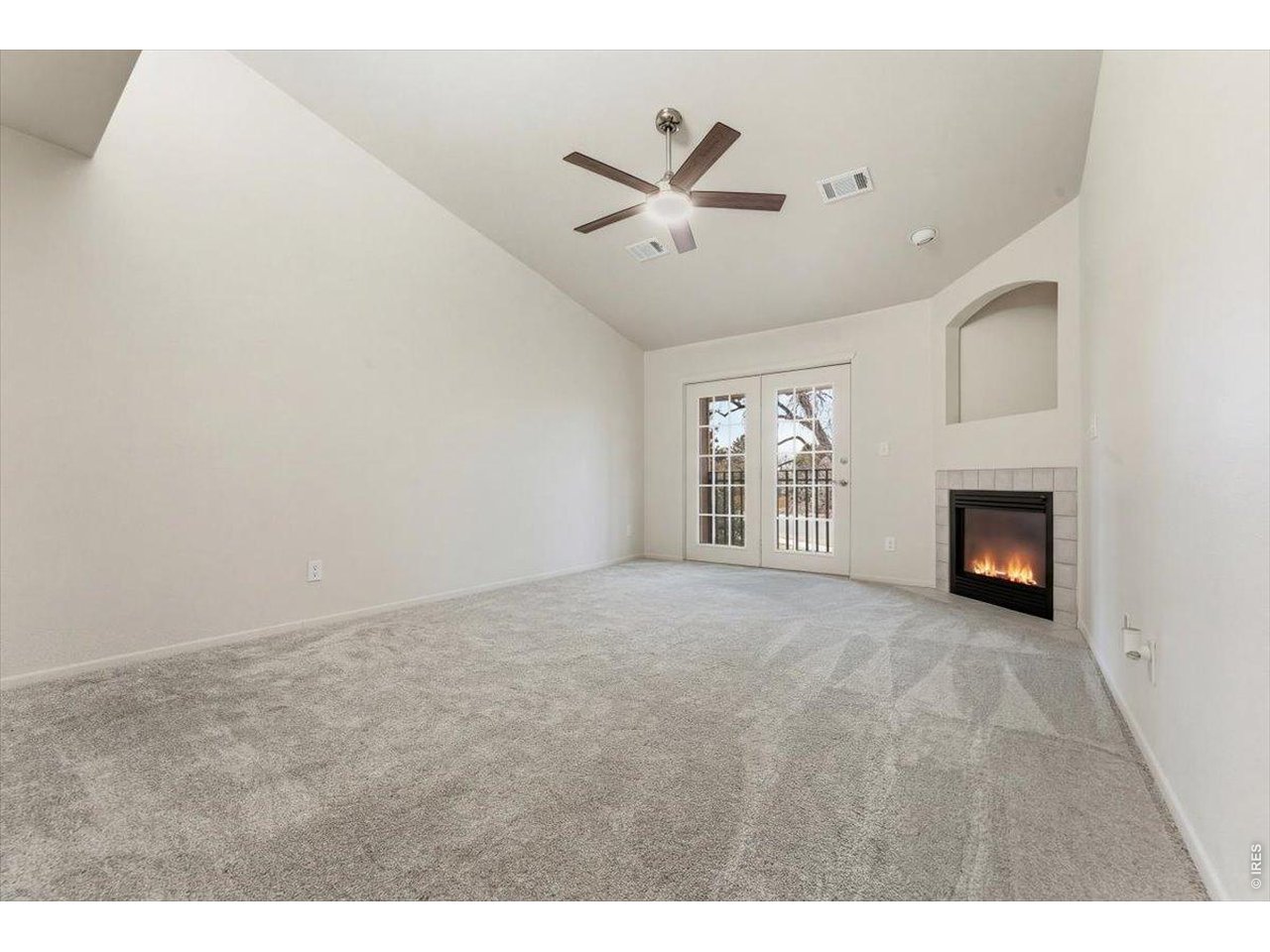 2551 West 24th Street, Unit A6 Greeley, CO 80634 - Photo 15 of 28 a view of an empty room with a fireplace