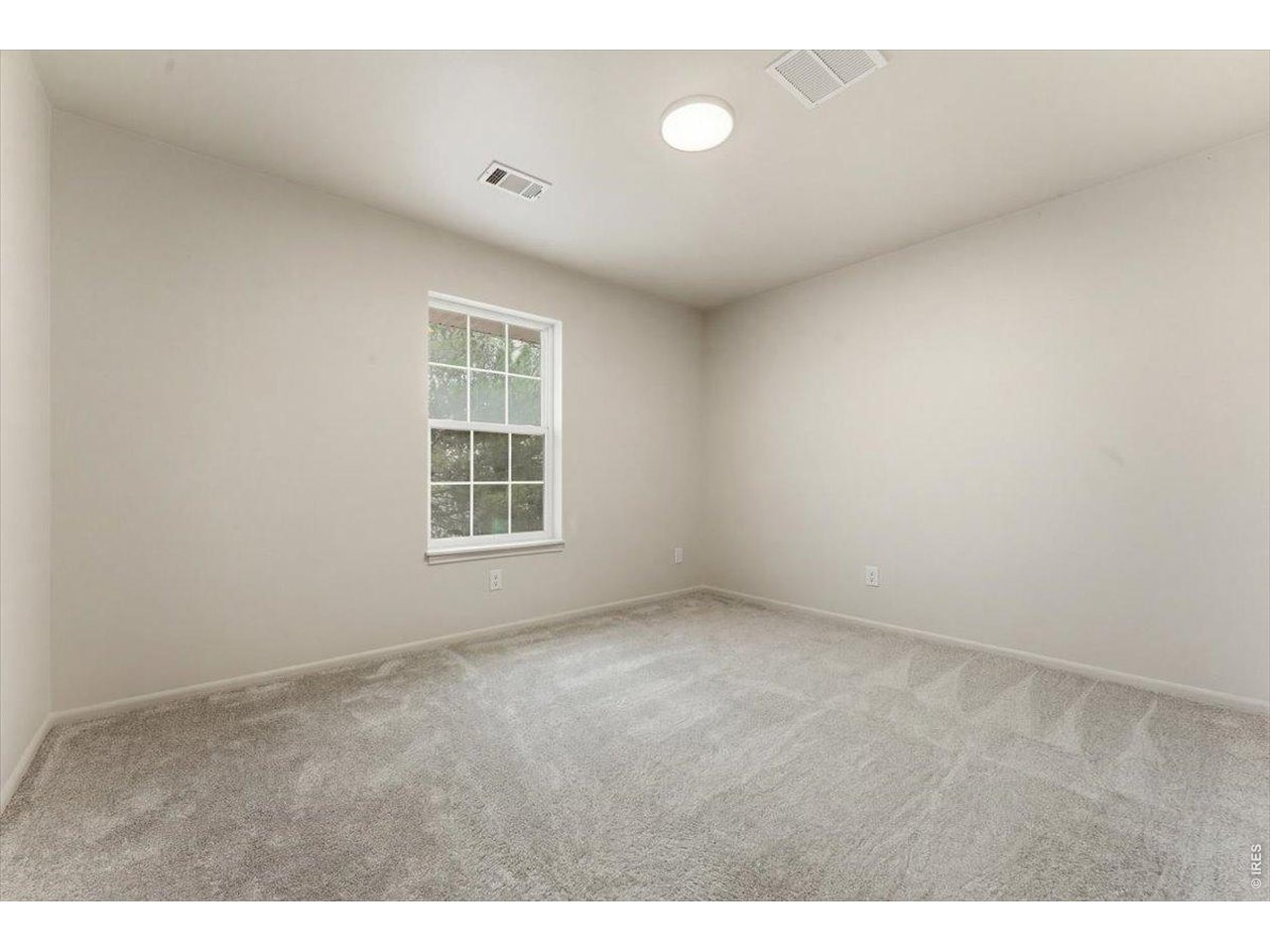 2551 West 24th Street, Unit A6 Greeley, CO 80634 - Photo 16 of 28 a view of an empty room with a window