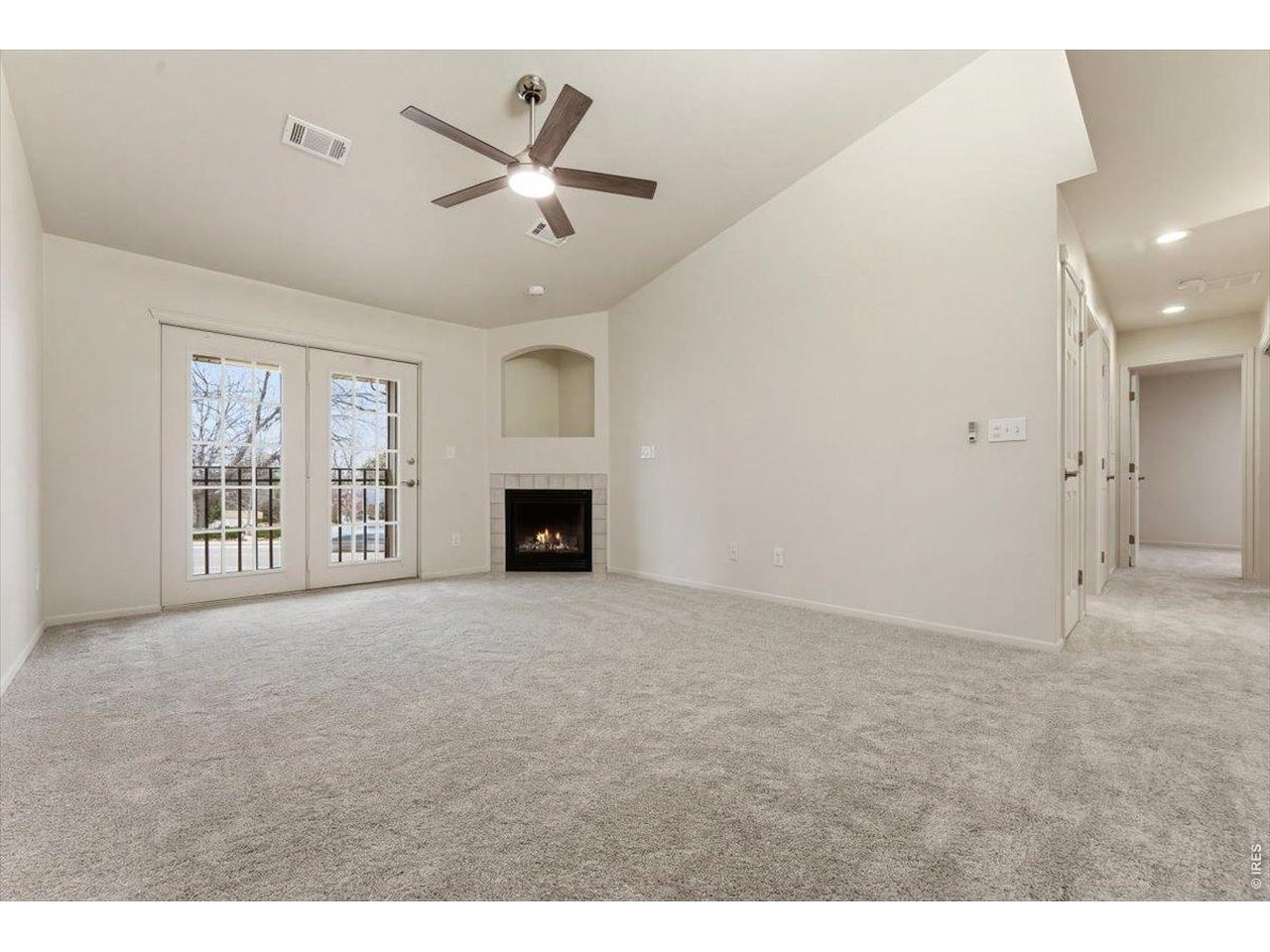 2551 West 24th Street, Unit A6 Greeley, CO 80634 - Photo 5 of 28 a view of an empty room with a fireplace