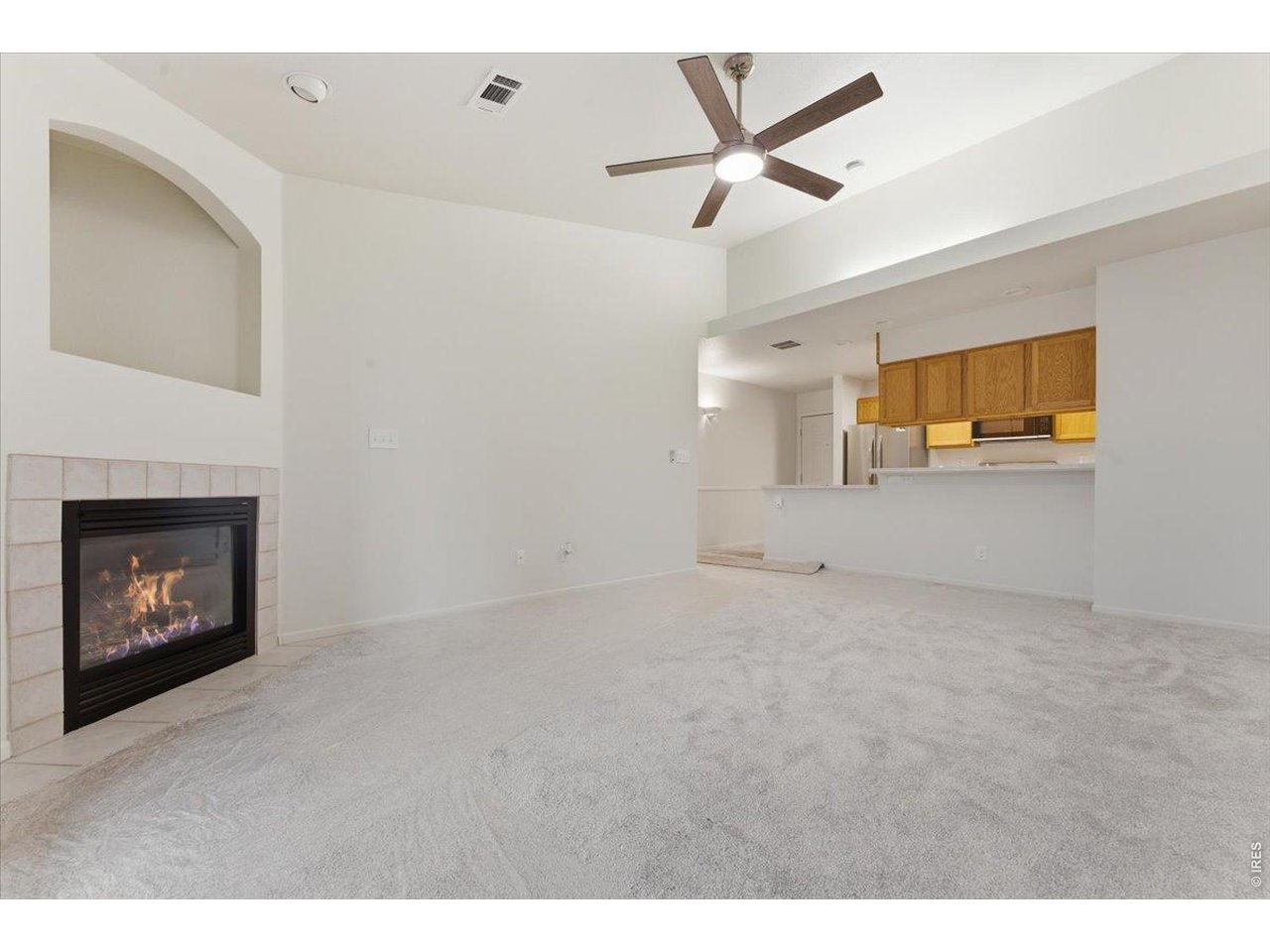 2551 West 24th Street, Unit A6 Greeley, CO 80634 - Photo 6 of 28 a view of an empty room with a fireplace