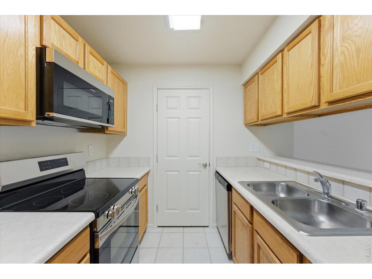 2551 West 24th Street, Unit A6 Greeley, CO 80634 - Photo 8 of 28 a kitchen with a sink stove and microwave