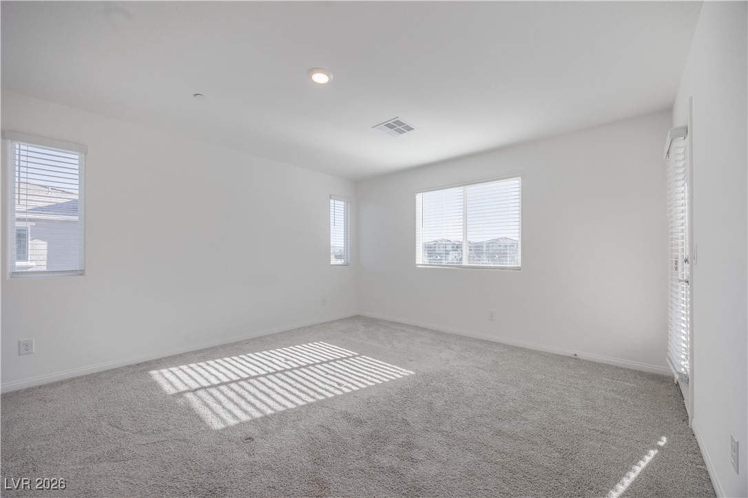 12185 Scarlet Ember Road, Unit 4 Las Vegas, NV 89183 - Photo 11 of 40 Carpeted empty room featuring baseboards and recessed lighting