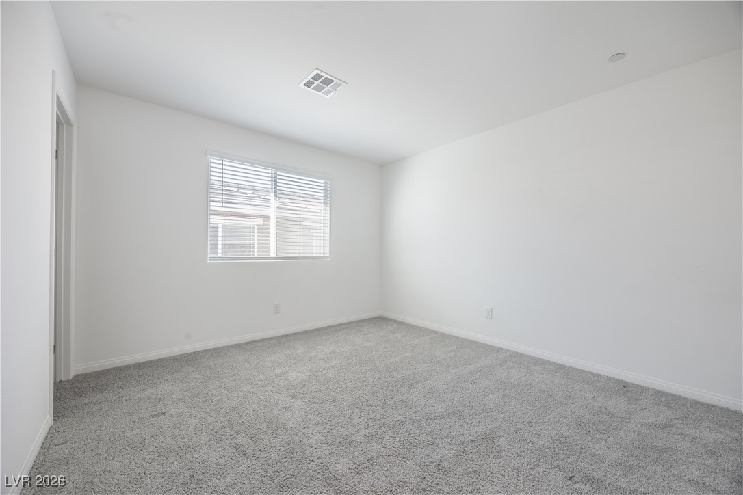 12185 Scarlet Ember Road, Unit 4 Las Vegas, NV 89183 - Photo 17 of 40 Spare room featuring light carpet and baseboards