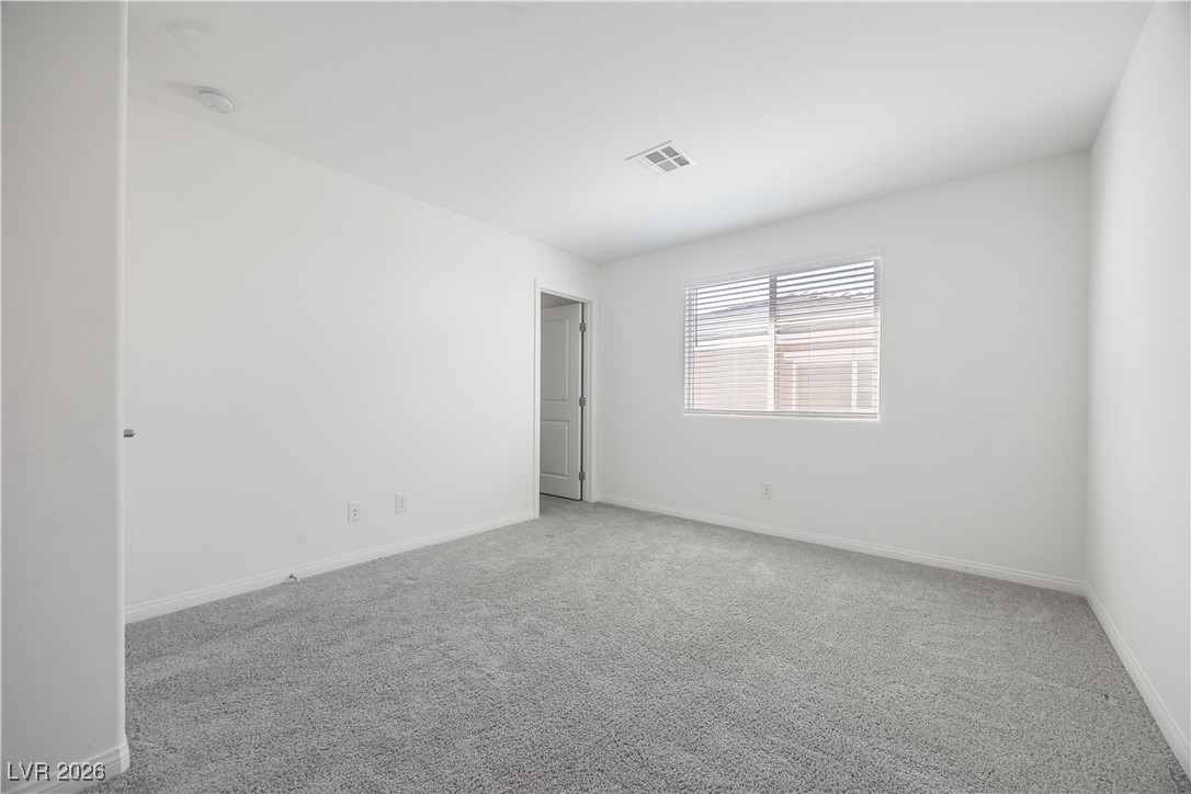 12185 Scarlet Ember Road, Unit 4 Las Vegas, NV 89183 - Photo 18 of 40 Carpeted empty room with baseboards
