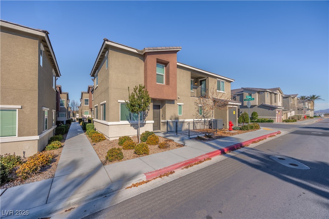12185 Scarlet Ember Road, Unit 4 Las Vegas, NV 89183 - Photo 24 of 40 View of asphalt street featuring sidewalks, a residential view, and curbs
