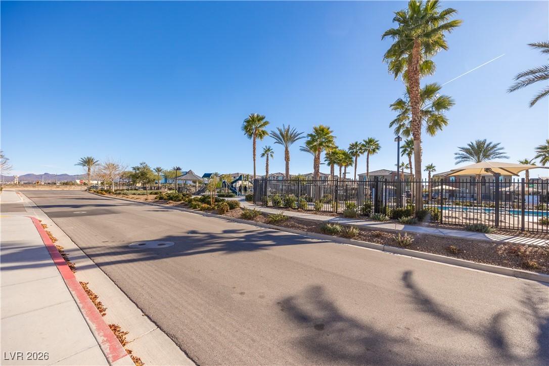 12185 Scarlet Ember Road, Unit 4 Las Vegas, NV 89183 - Photo 25 of 40 View of asphalt road featuring sidewalks and curbs