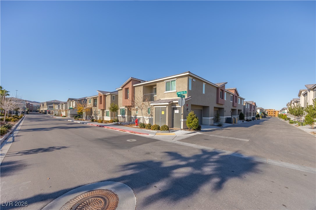 12185 Scarlet Ember Road, Unit 4 Las Vegas, NV 89183 - Photo 26 of 40 View of asphalt street featuring curbs and a residential view