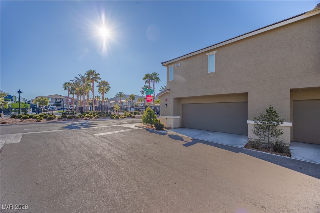 12185 Scarlet Ember Road, Unit 4 Las Vegas, NV 89183 - Photo 29 of 40 View of asphalt road with traffic signs and a residential view