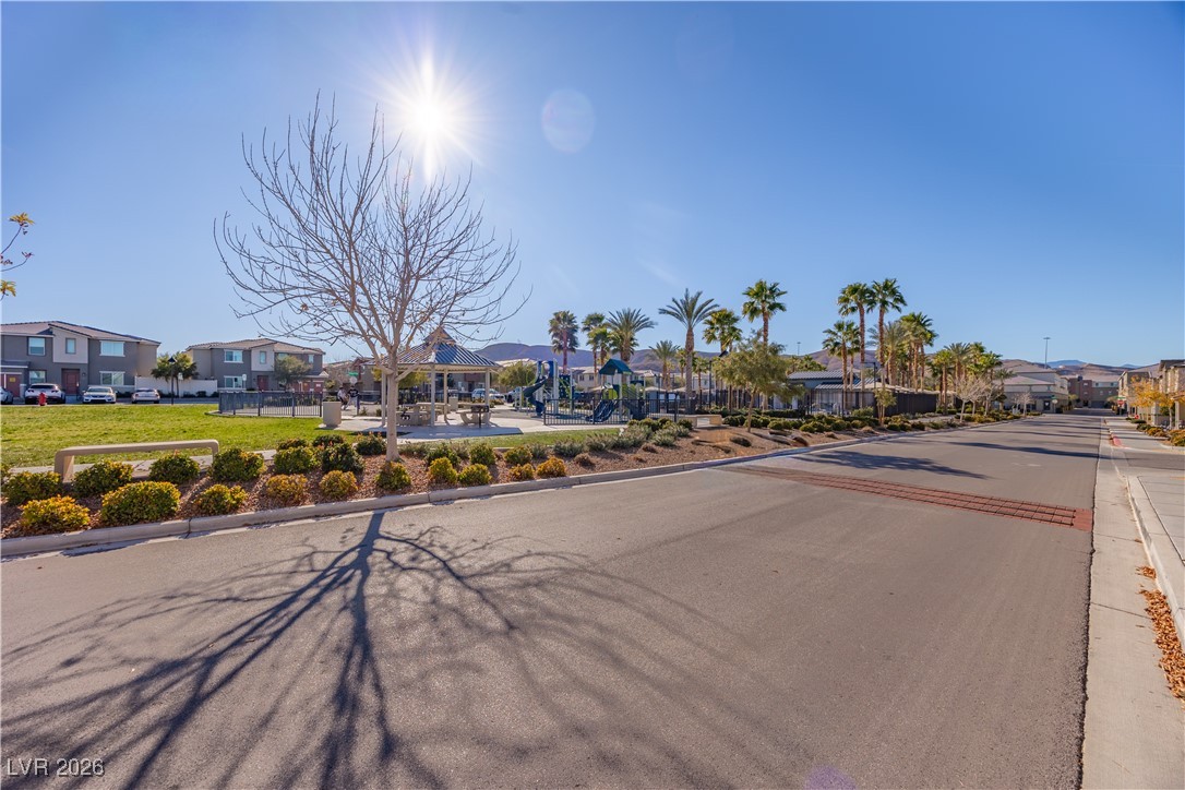 12185 Scarlet Ember Road, Unit 4 Las Vegas, NV 89183 - Photo 31 of 40 View of asphalt road with a residential view and curbs