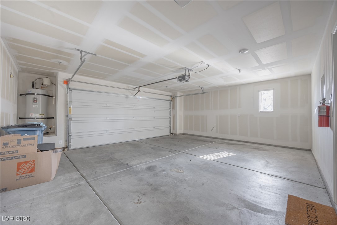 12185 Scarlet Ember Road, Unit 4 Las Vegas, NV 89183 - Photo 8 of 40 Garage featuring secured water heater