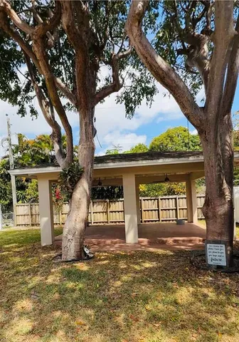 a view of a house with a tree in front