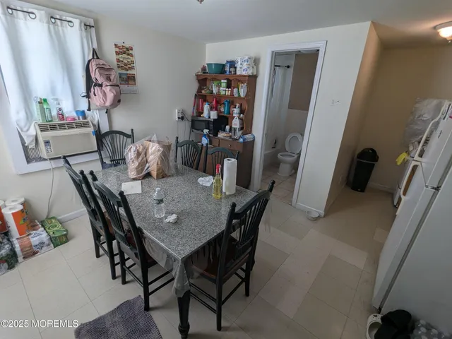 a room with furniture a refrigerator and a sink