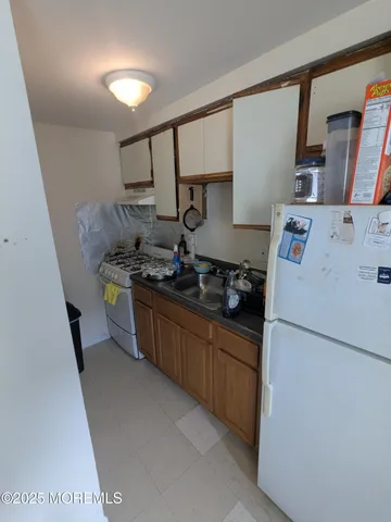 a living room with furniture and a book shelf
